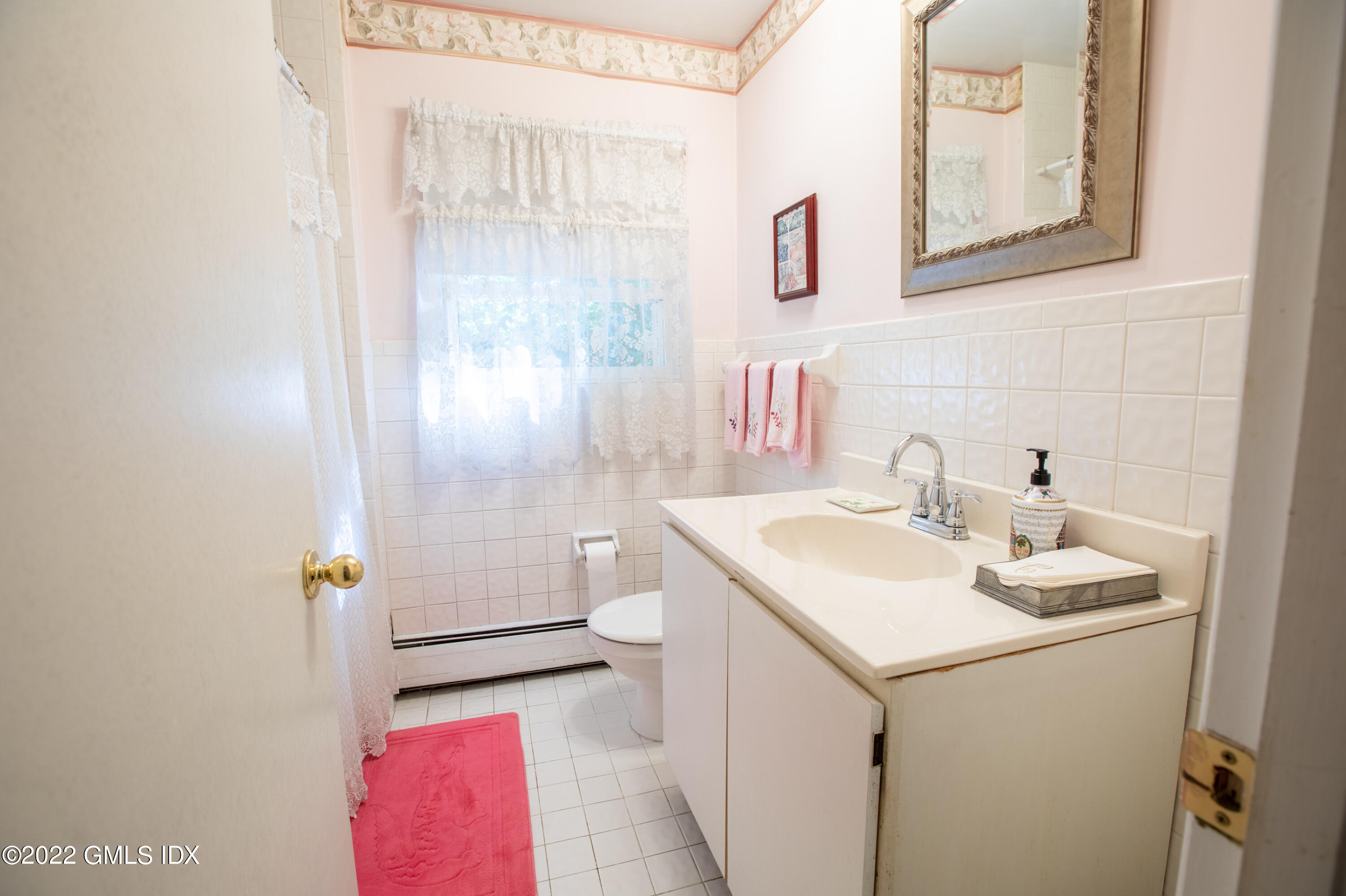 65 Laddins Rock Road Old Greenwich, CT 06870 - Photo 21 of 40 a bathroom with a sink and mirror