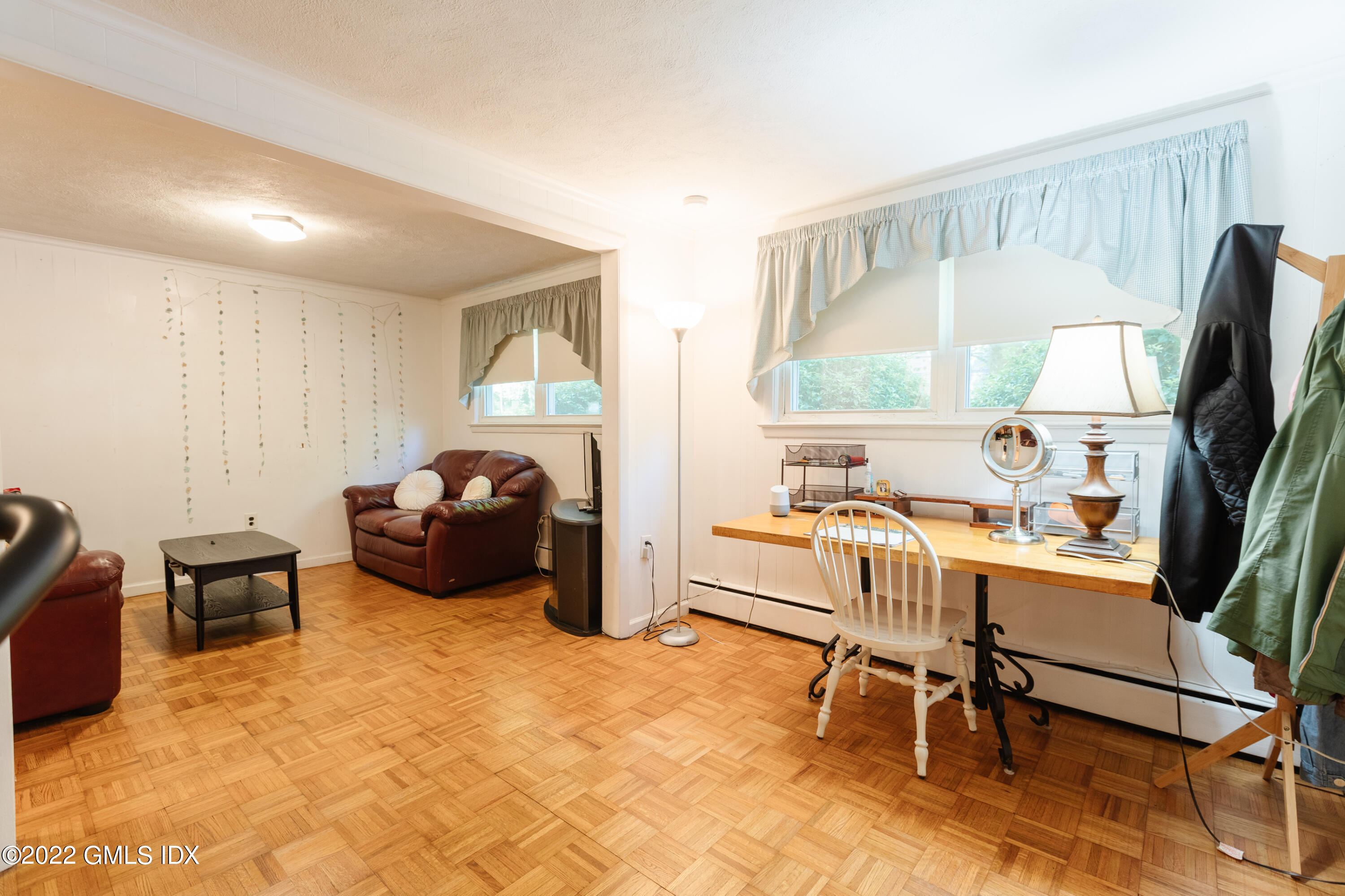 65 Laddins Rock Road Old Greenwich, CT 06870 - Photo 25 of 40 a living room with furniture a window and a flat screen tv