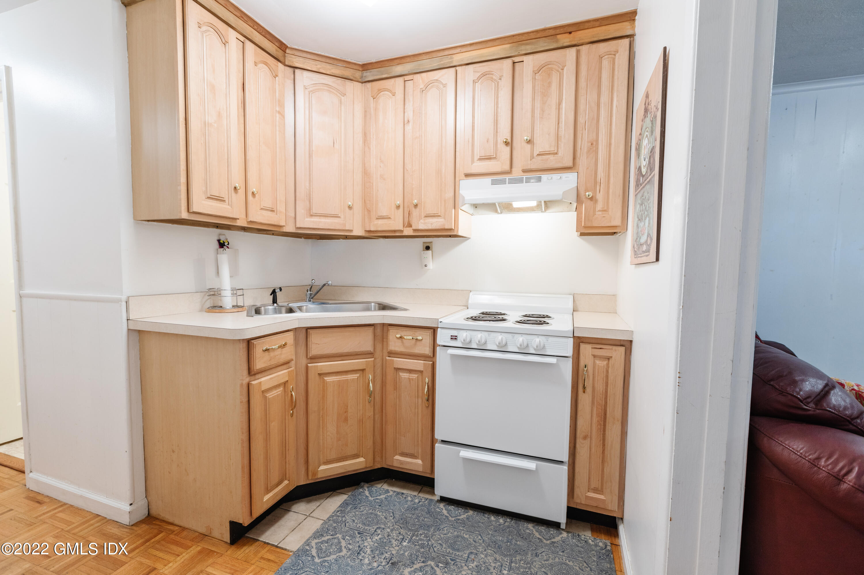 65 Laddins Rock Road Old Greenwich, CT 06870 - Photo 26 of 40 a kitchen with granite countertop white cabinets and white appliances