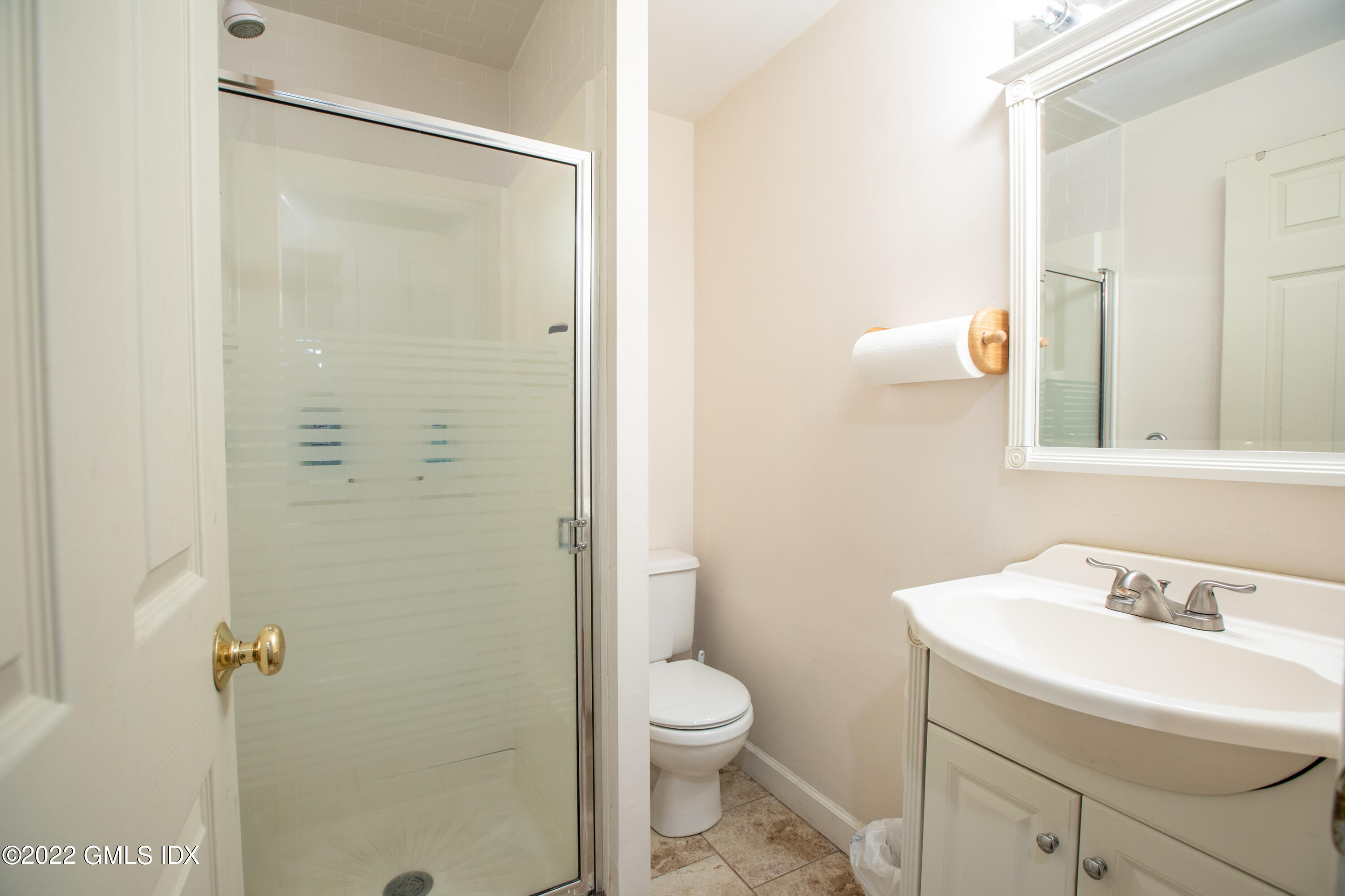 65 Laddins Rock Road Old Greenwich, CT 06870 - Photo 27 of 40 a bathroom with a sink a toilet and shower