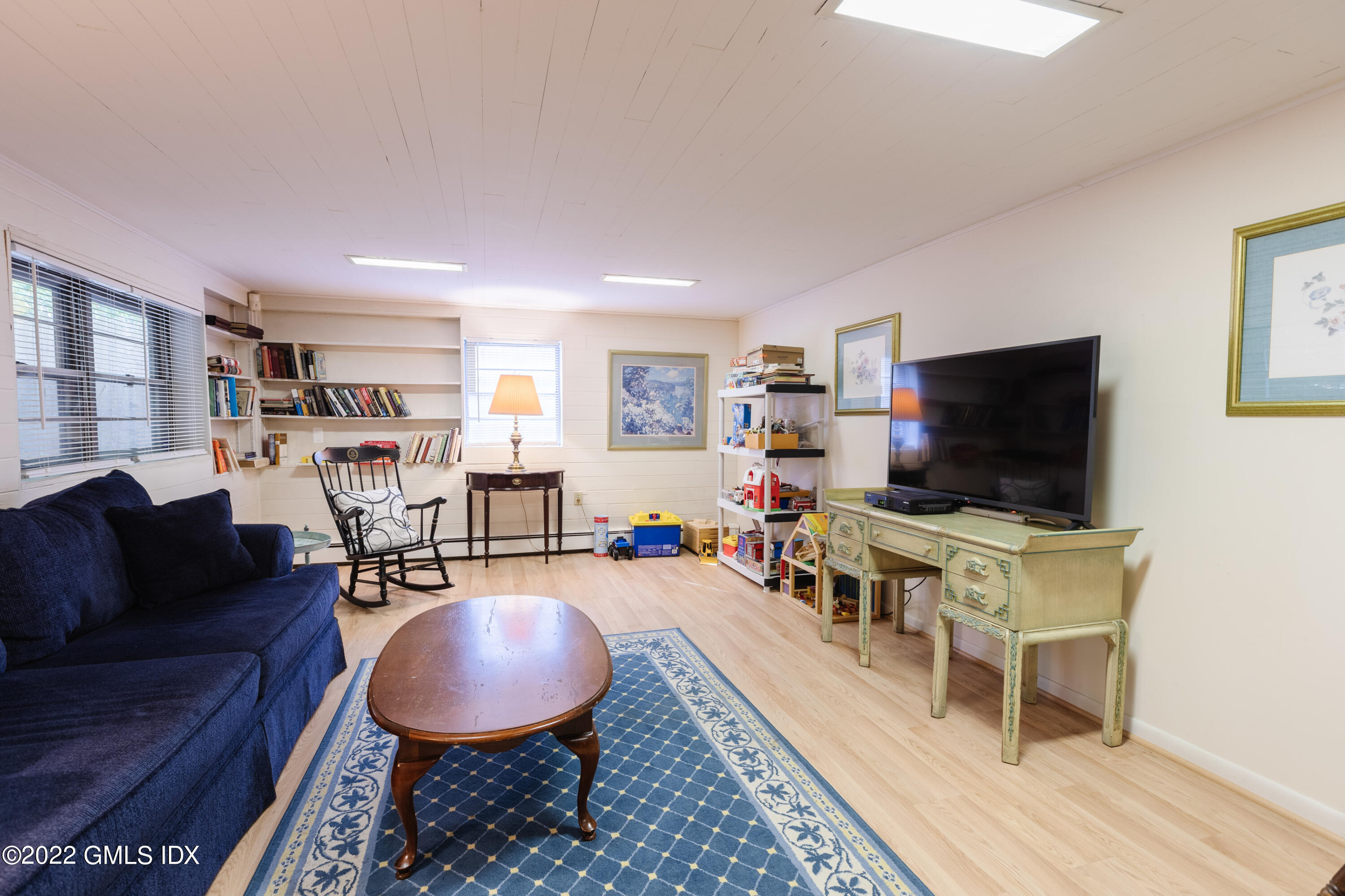 65 Laddins Rock Road Old Greenwich, CT 06870 - Photo 30 of 40 a living room with furniture and a flat screen tv