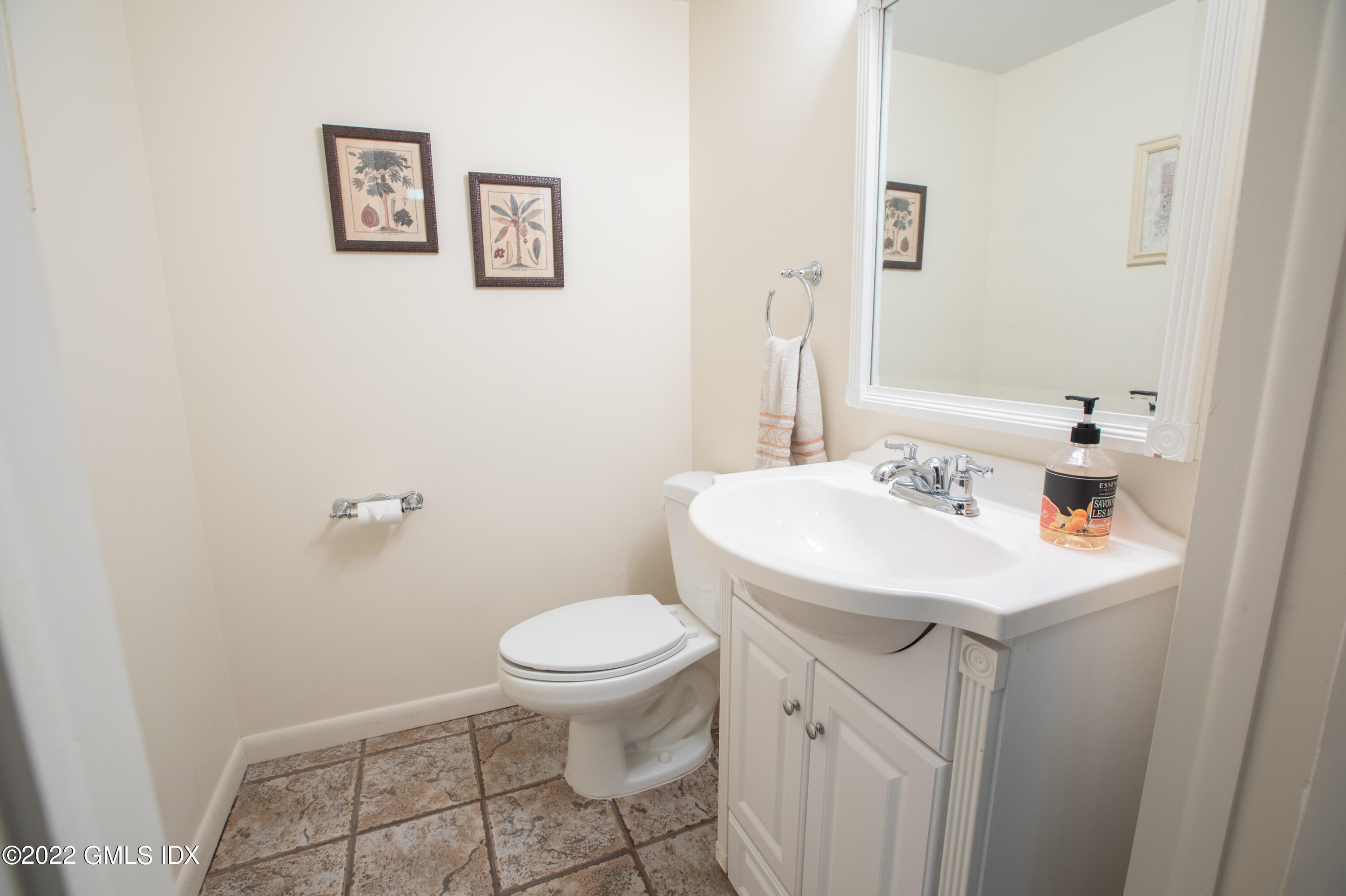 65 Laddins Rock Road Old Greenwich, CT 06870 - Photo 35 of 40 a bathroom with a sink toilet and a mirror