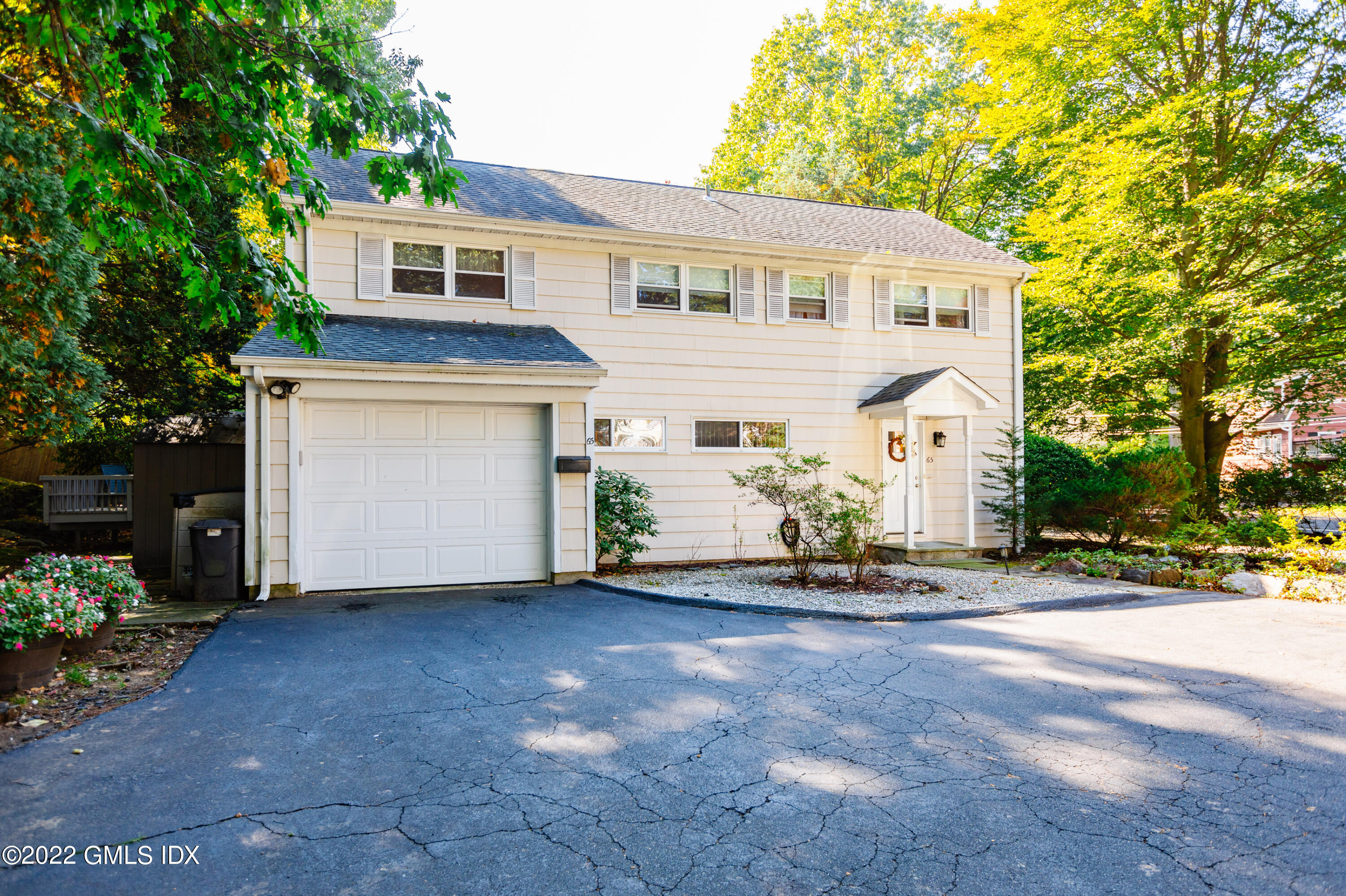 65 Laddins Rock Road Old Greenwich, CT 06870 - Photo 36 of 40 a view of a house with backyard and a tree