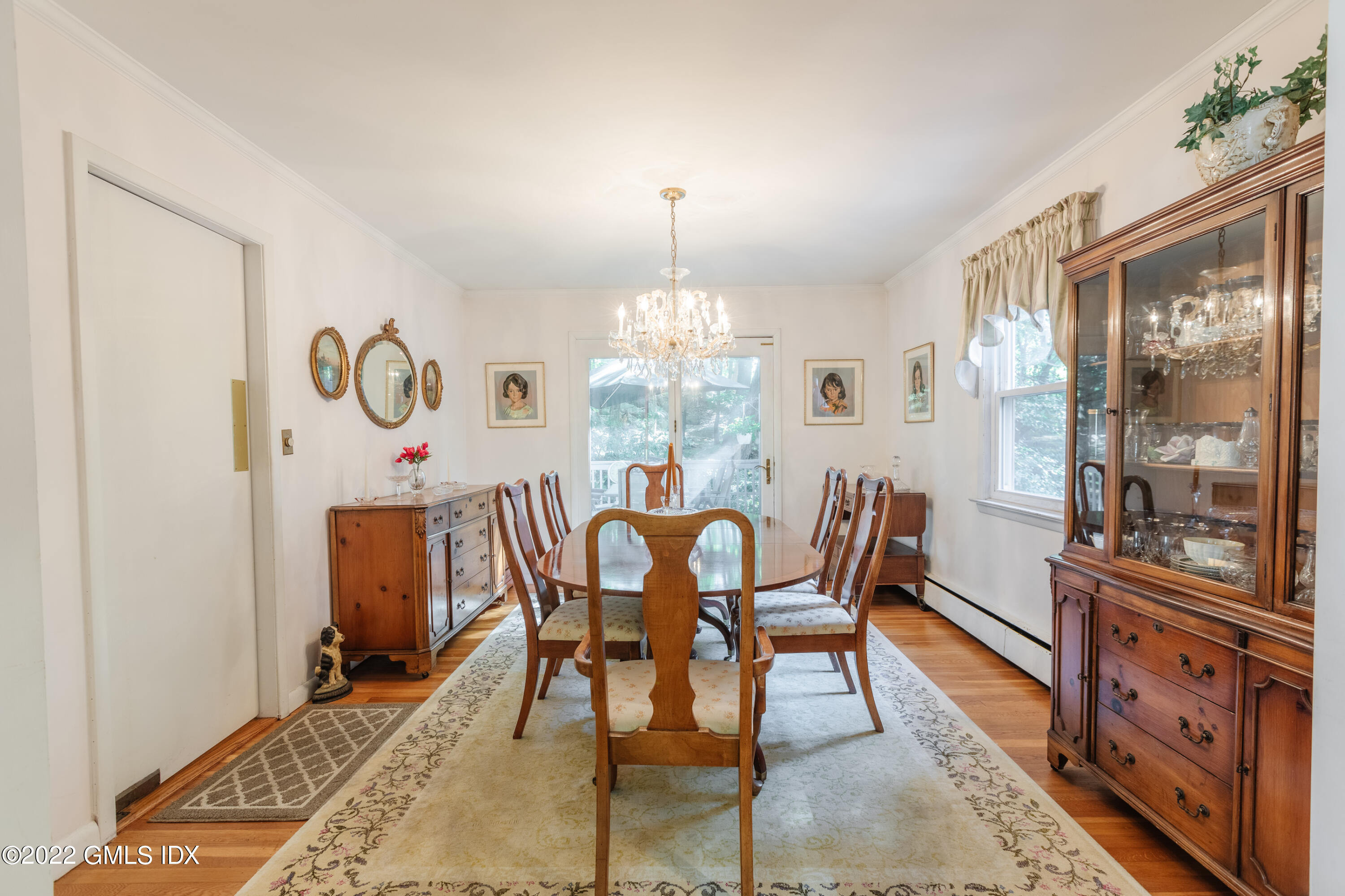 65 Laddins Rock Road Old Greenwich, CT 06870 - Photo 8 of 40 a dining room with furniture a chandelier and wooden floor