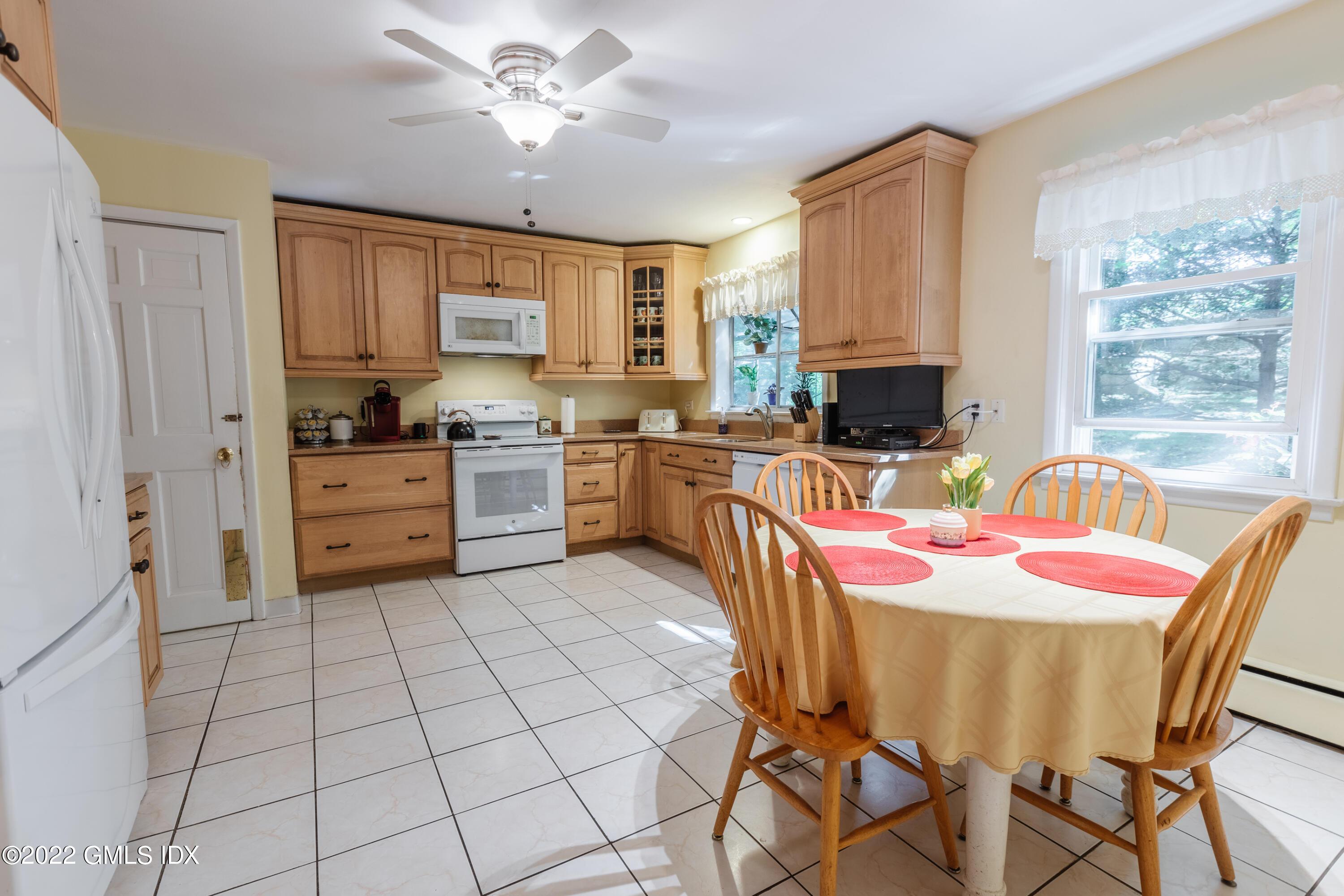 65 Laddins Rock Road Old Greenwich, CT 06870 - Photo 10 of 40 a kitchen with a stove a sink and a refrigerator