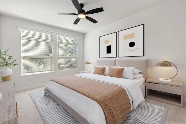 a bedroom with a bed and a large window