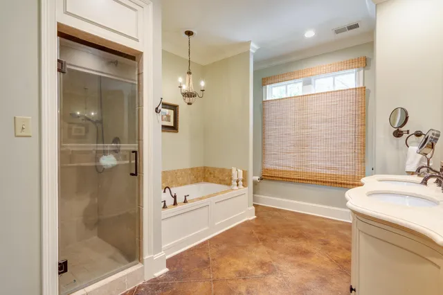 a bathroom with a tub a sink and a shower