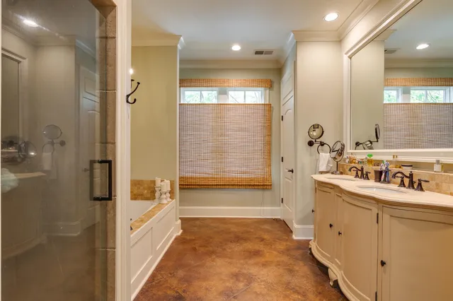 a bathroom with a tub sink and mirror