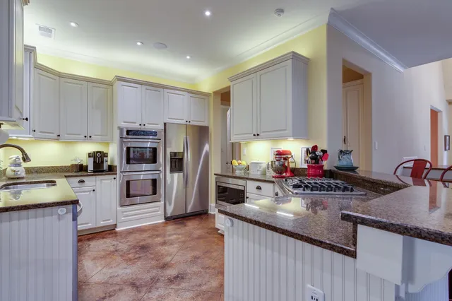 a kitchen with a sink stove and refrigerator