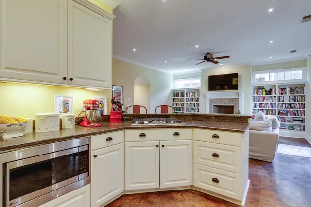 a kitchen with granite countertop a stove and cabinets