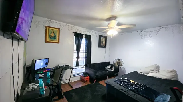 a bedroom with bed and a chandelier