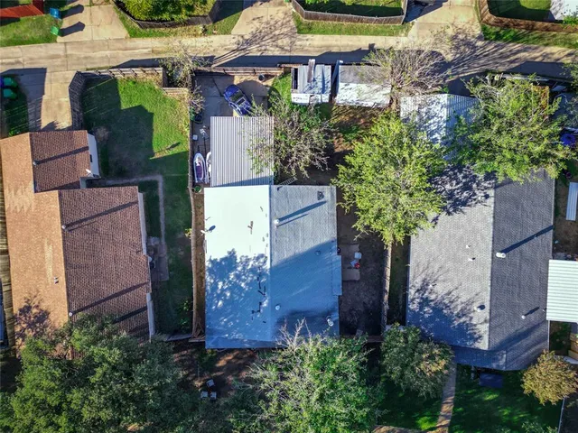 an aerial view of a house with yard and outdoor seating