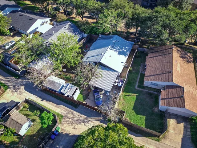 an aerial view of residential houses with outdoor space
