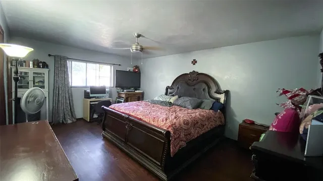 a bedroom with a bed and a mirror