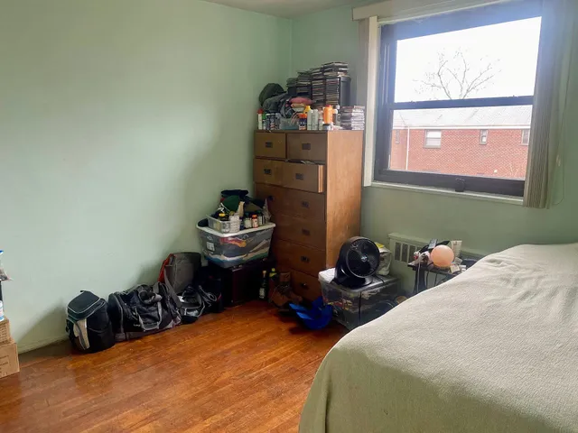 a bedroom with bed and a window