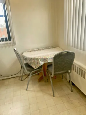 a dining room with furniture and a window