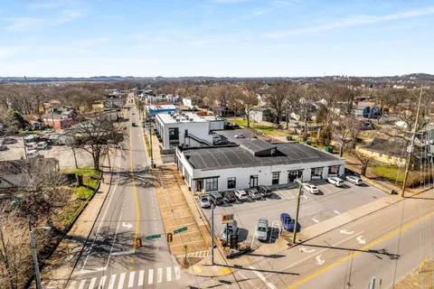 an aerial view of a houses with a city view
