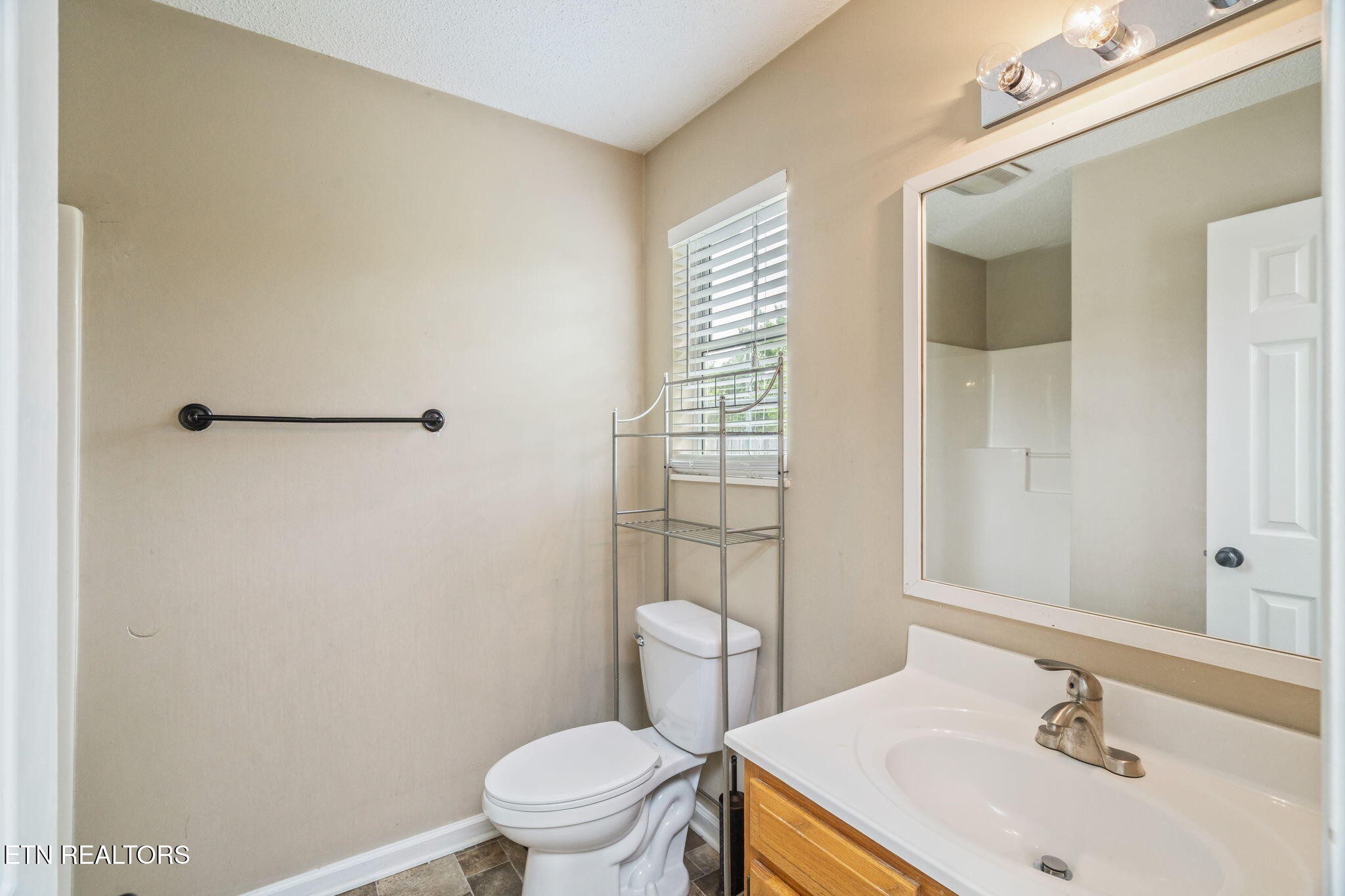 7536 Gary White Road Corryton, TN 37721 - Photo 15 of 26 a bathroom with a sink toilet and shower