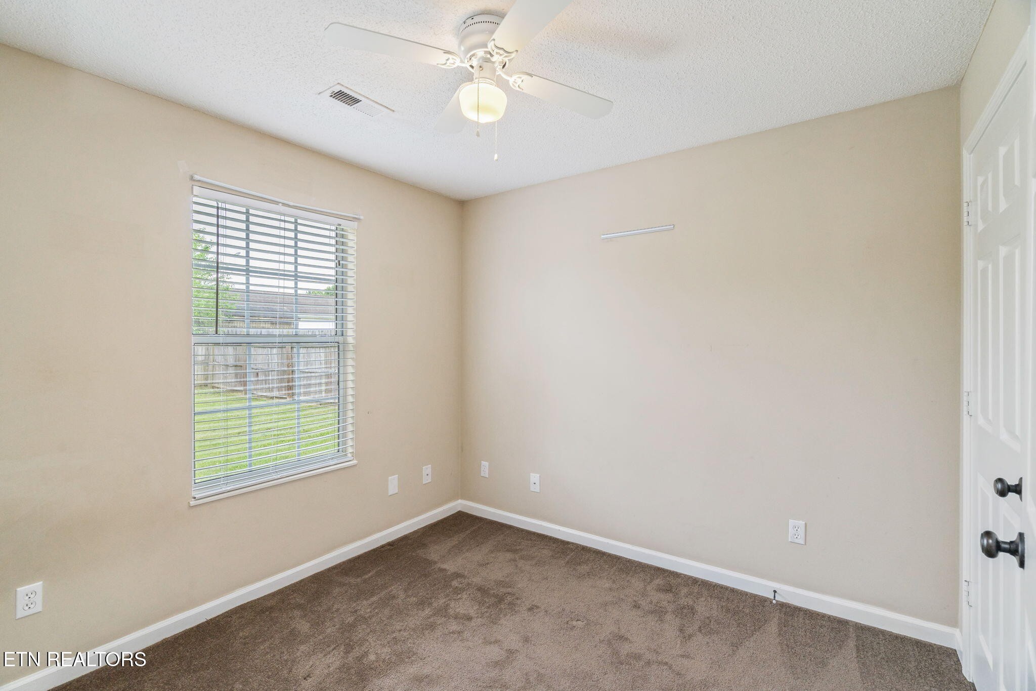 7536 Gary White Road Corryton, TN 37721 - Photo 20 of 26 an empty room with windows and fan