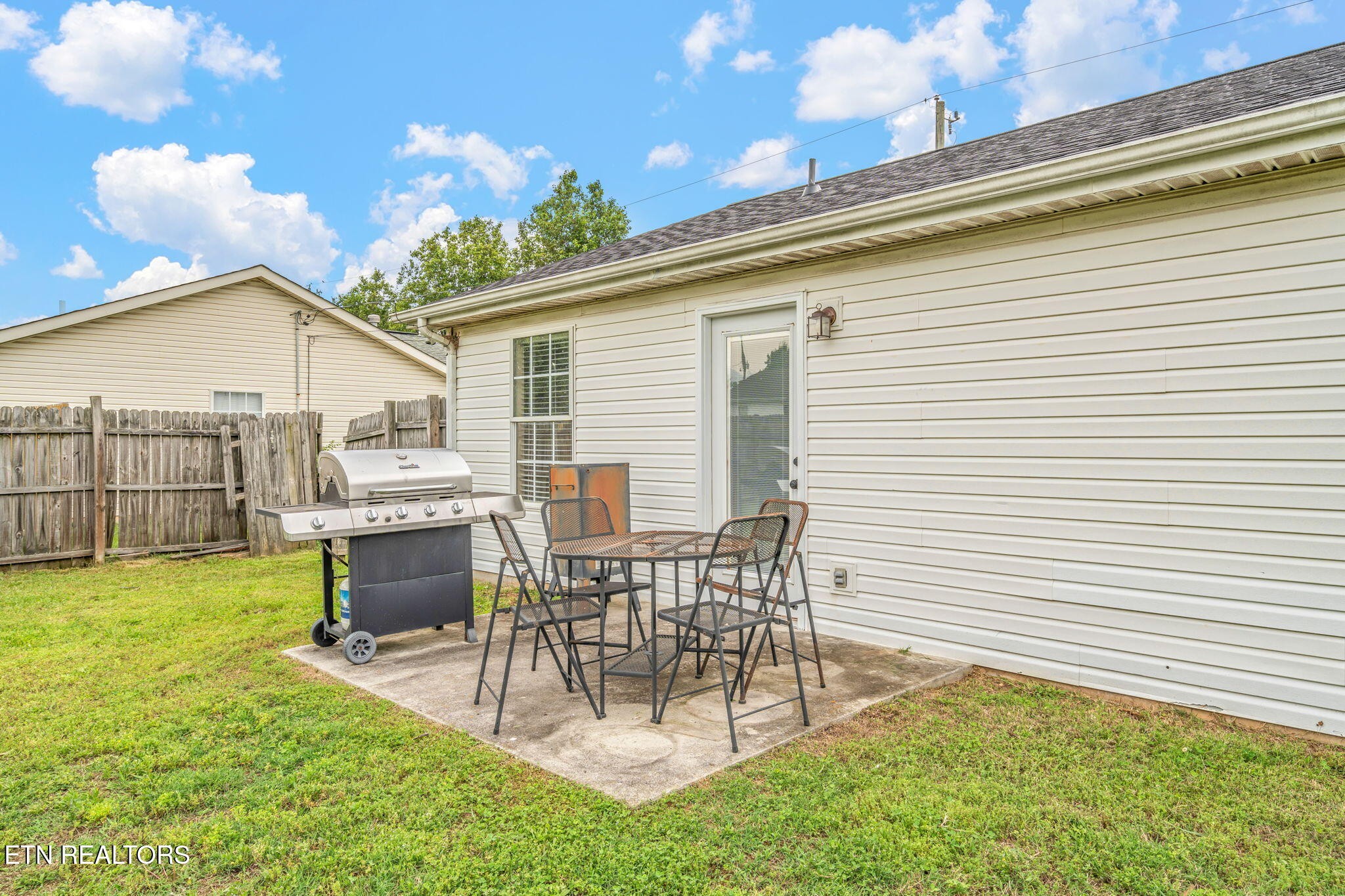 7536 Gary White Road Corryton, TN 37721 - Photo 26 of 26 a view of a patio with table and chairs and potted plants