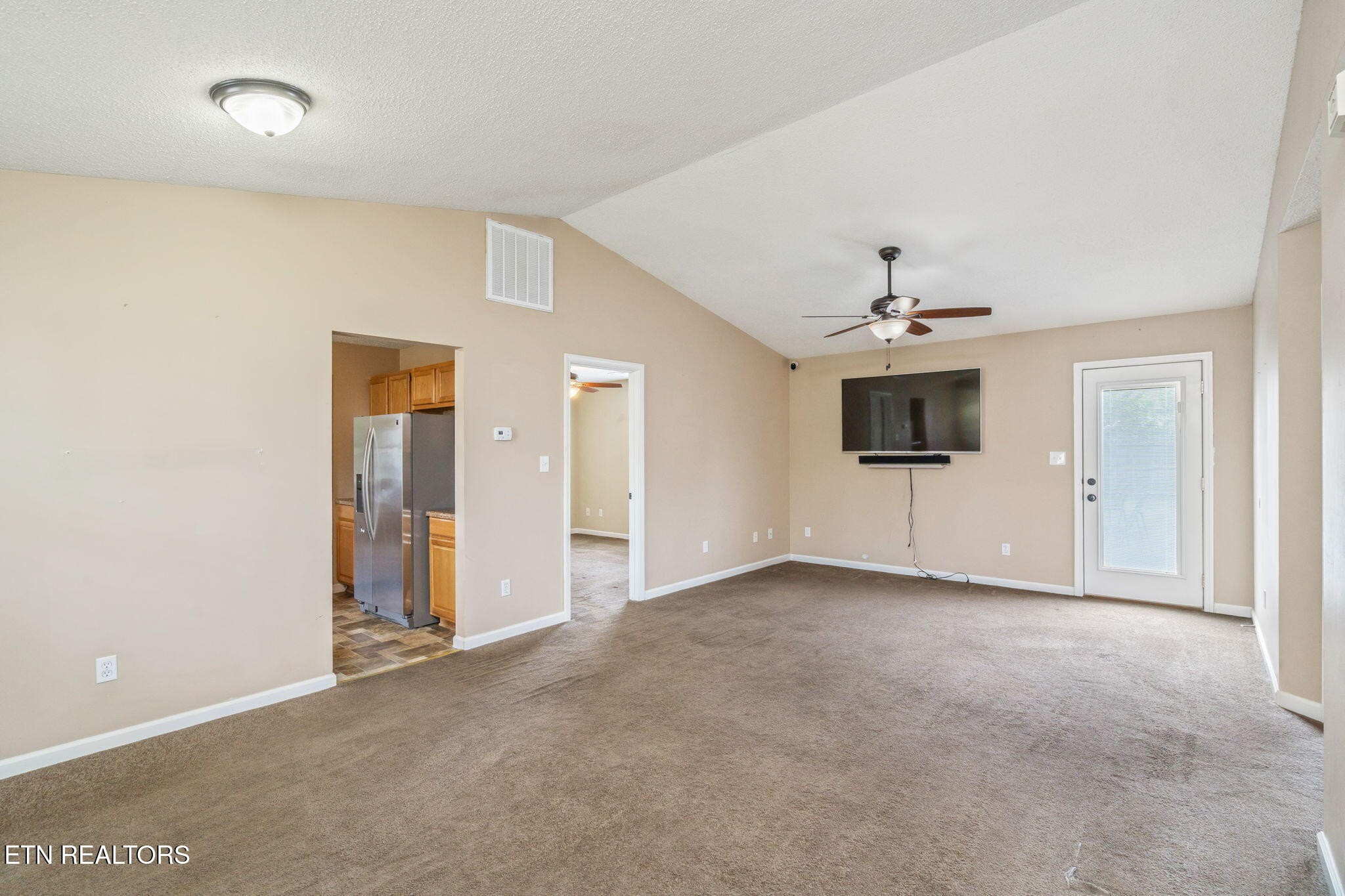 7536 Gary White Road Corryton, TN 37721 - Photo 5 of 26 an empty room with chandelier fan and windows