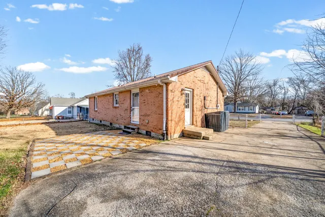 a view of a house with snow on the road