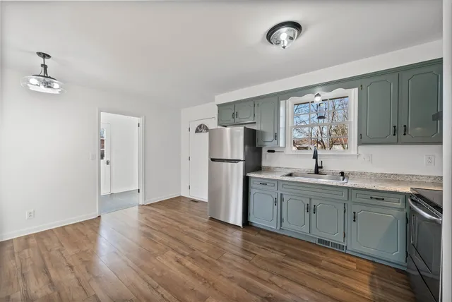 a kitchen with refrigerator cabinets and a sink
