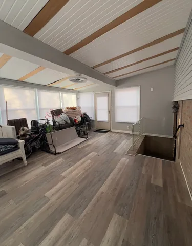 a view of a room with lots of furniture and a rug