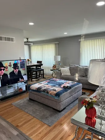 a living room with furniture and wooden floor