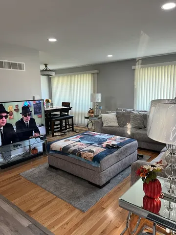 a living room with furniture and wooden floor