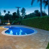 a view of a swimming pool with a yard