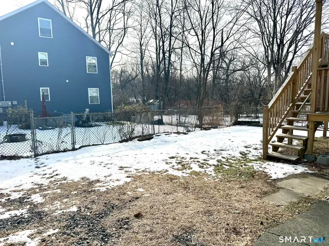 a view of a house with snow on the road