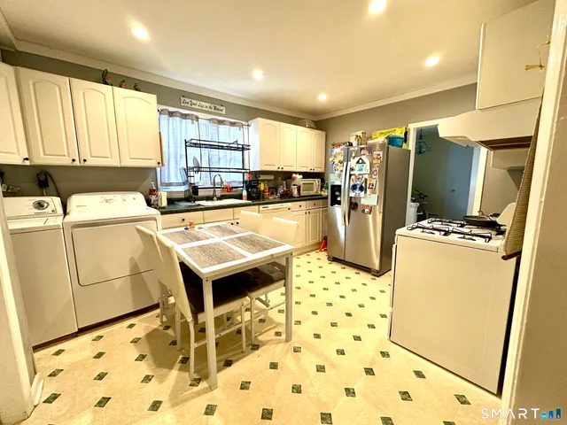 a kitchen with sink refrigerator and window