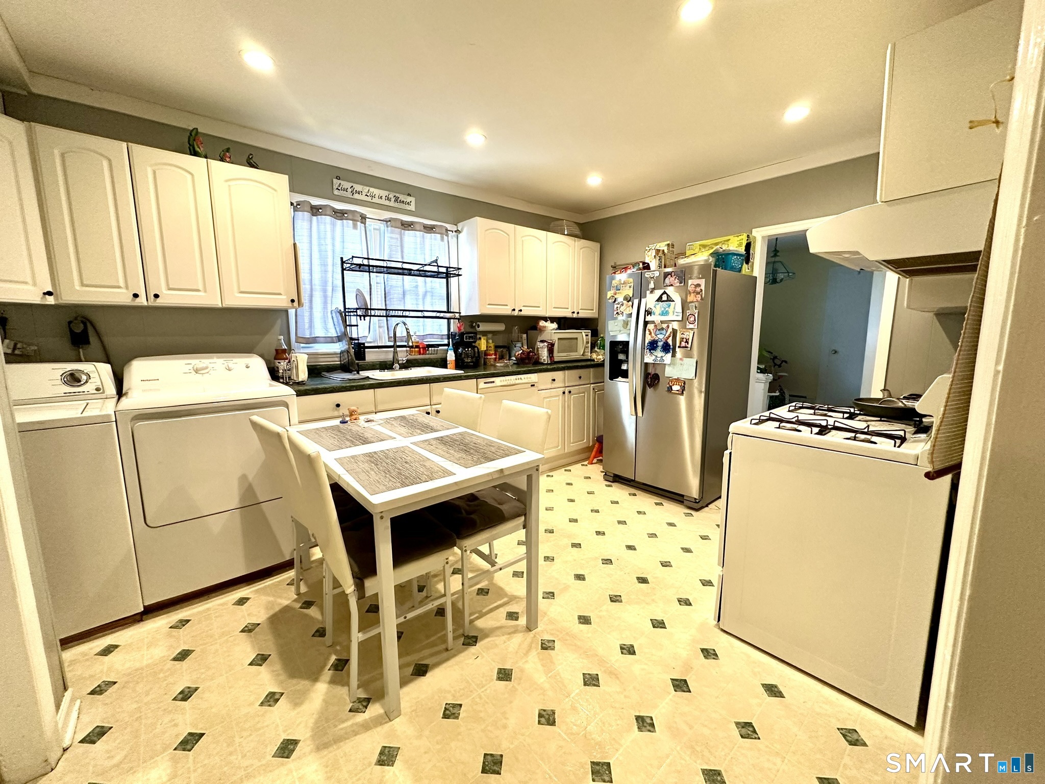 39 Pierce Street Fairfield, CT 06825 - Photo 5 of 18 a kitchen with sink refrigerator and window