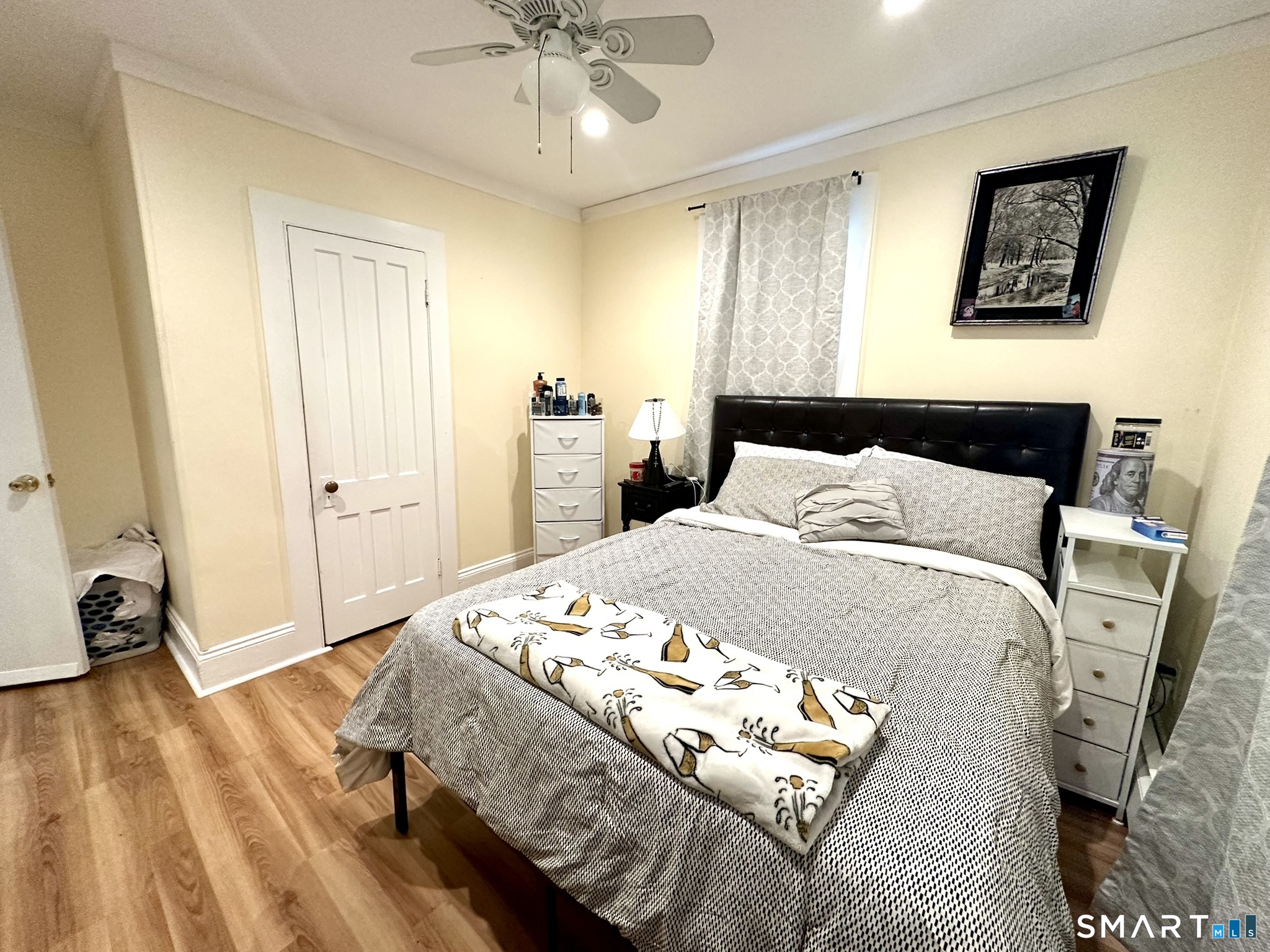 39 Pierce Street Fairfield, CT 06825 - Photo 7 of 18 a bedroom with a bed and a chandelier