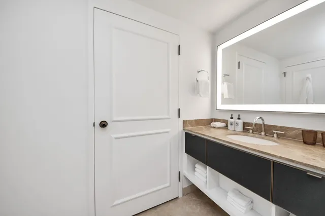 a bathroom with a toilet a sink and shower