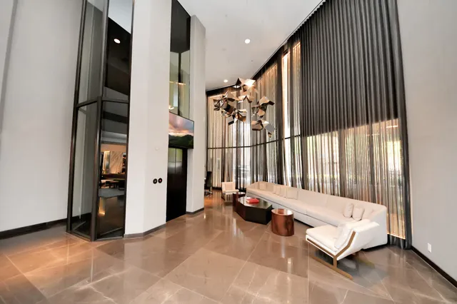 a lobby with furniture and floor to ceiling window