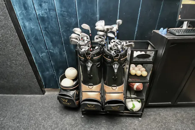 a room with stainless steel appliances furniture and wooden floor