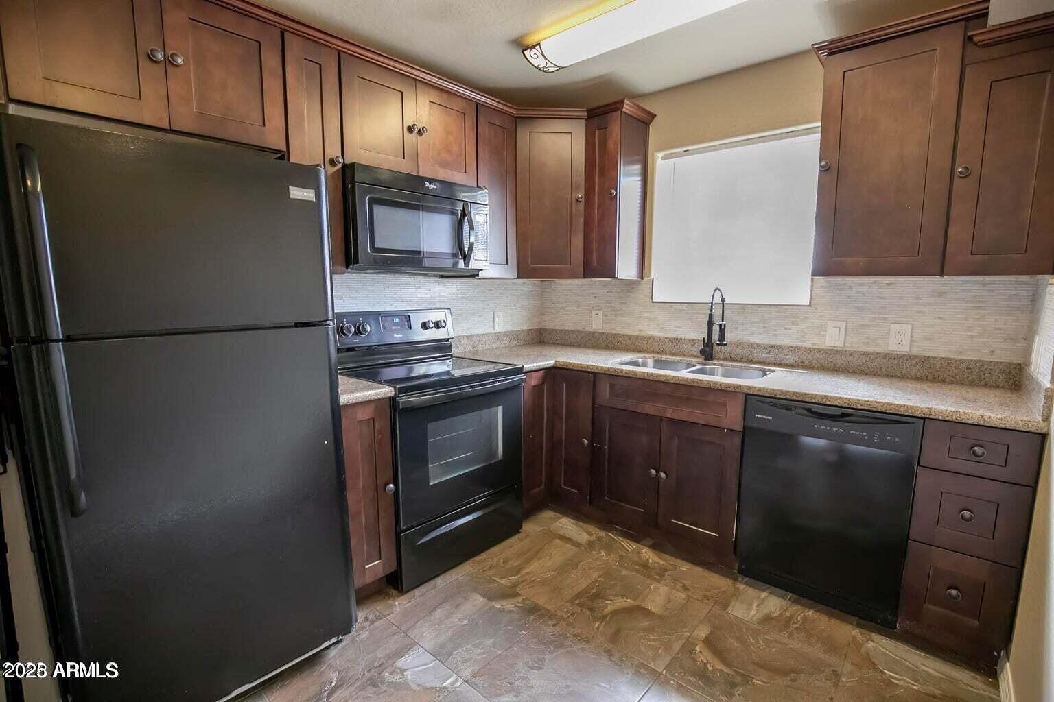 1161 East 5th Avenue, Unit 102 Mesa, AZ 85204 - Photo 2 of 9 a kitchen with stainless steel appliances granite countertop a refrigerator a stove a sink and a microwave