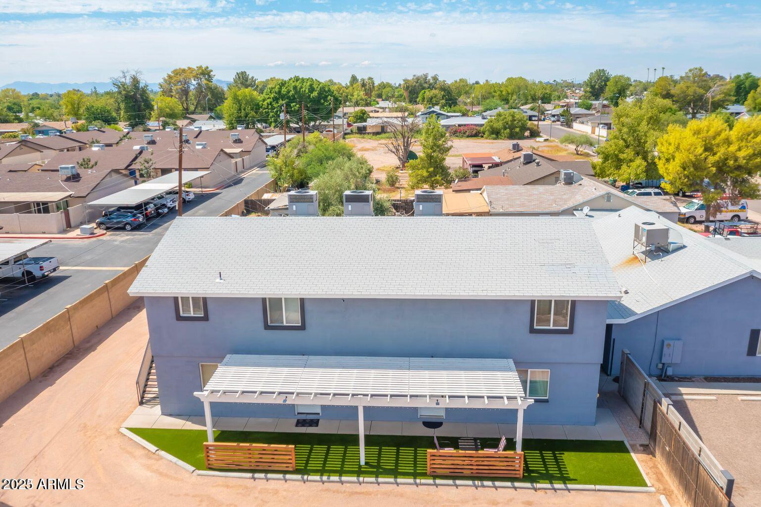 1161 East 5th Avenue, Unit 102 Mesa, AZ 85204 - Photo 8 of 9 a view of a house with a swimming pool