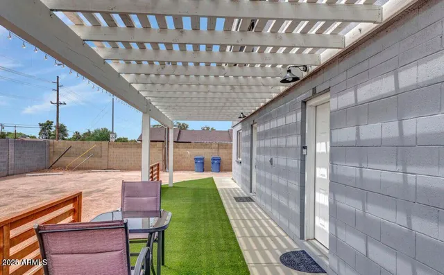 a patio with table and chairs