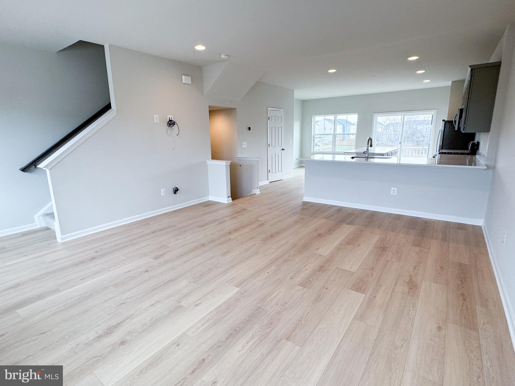 116 Flaxen Mane Court Stephenson, VA 22656 - Photo 11 of 28 a view of a big room with wooden floor and windows