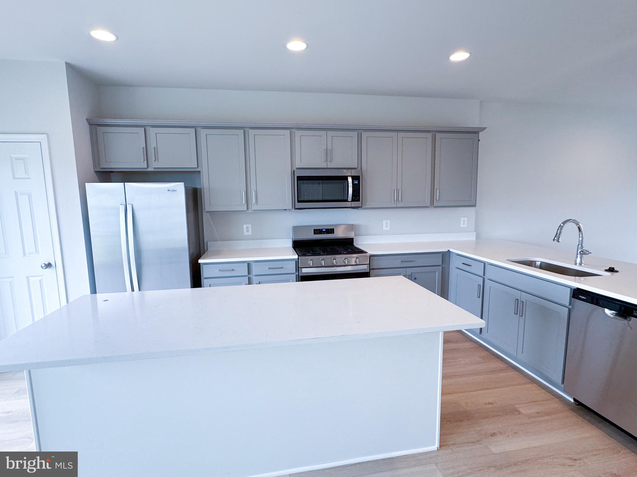 116 Flaxen Mane Court Stephenson, VA 22656 - Photo 6 of 28 a kitchen with stainless steel appliances a refrigerator sink and microwave