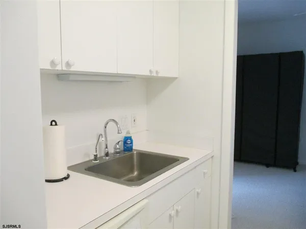 a kitchen with a sink and cabinets