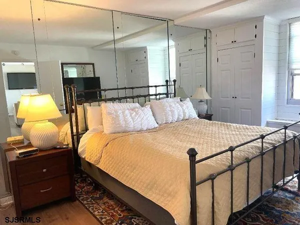 a bedroom with a bed a lamp and window