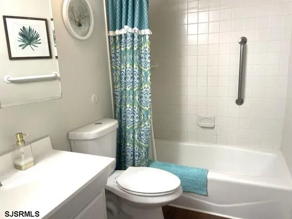 a white toilet sitting next to a bath tub