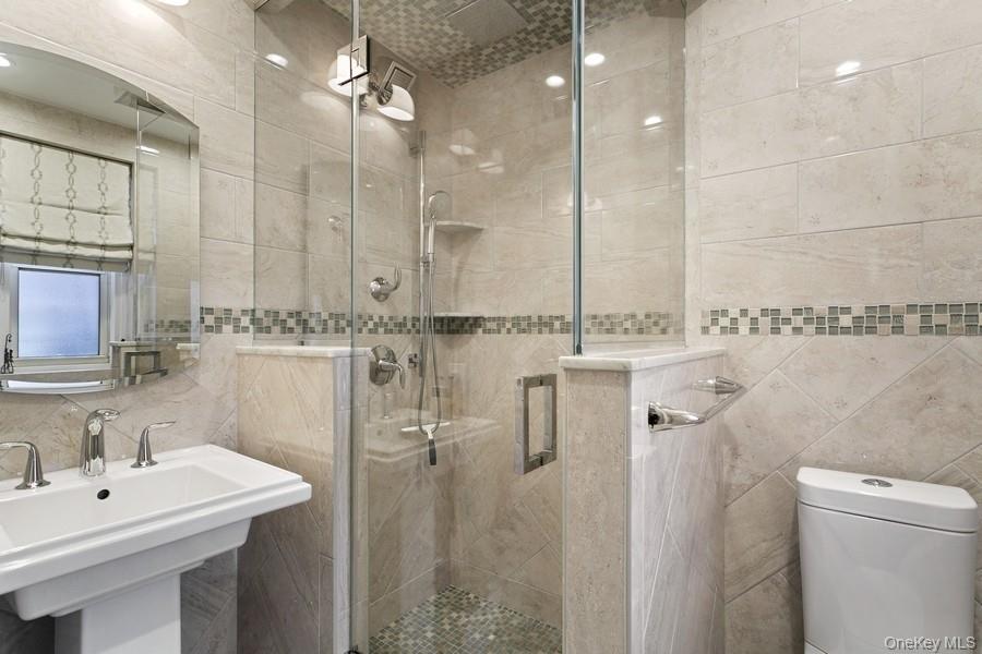 250 Bronxville Road, Unit 3I Bronxville, NY 10708 - Photo 11 of 17 a bathroom with a sink a toilet a mirror and shower