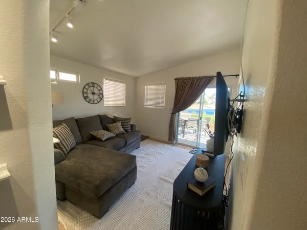 a living room with furniture and a chandelier