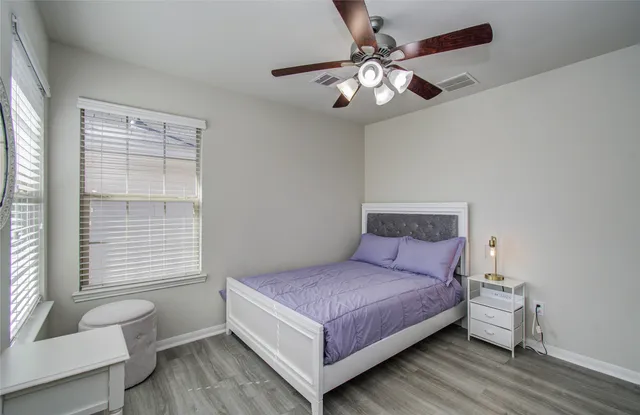 a bedroom with a large bed and a chandelier