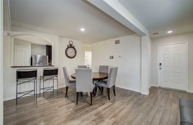 a view of a dining room with furniture and wooden floor